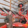 Gage Bischoff with his KUHN SR 112 GII SpeedRake wheel rake.