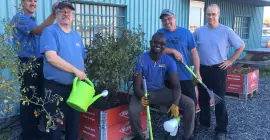 Ste-Madeleine employees gather around the garden