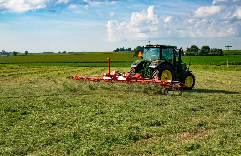KUHN GF 7803 THA rotary tedder in hayfield