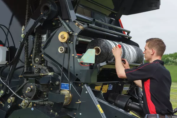 A roll of net wrap stored inside the baler